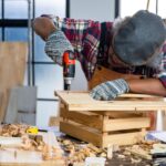 professional-carpenter-man-working-with-woodwork-industry-tool-construction-craftsman-person-workshop-with-timber-and-equipment-wood-work-free-photo